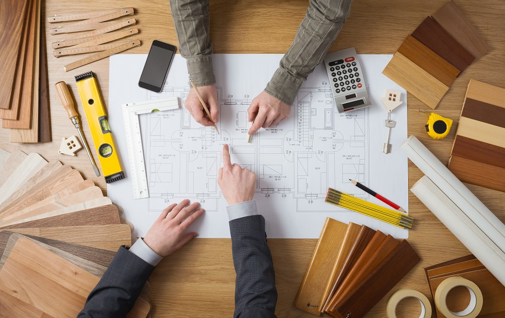 An architect and structural engineer working over a plan_what is the difference between the two professions_blog image_Essex Structural Engineers